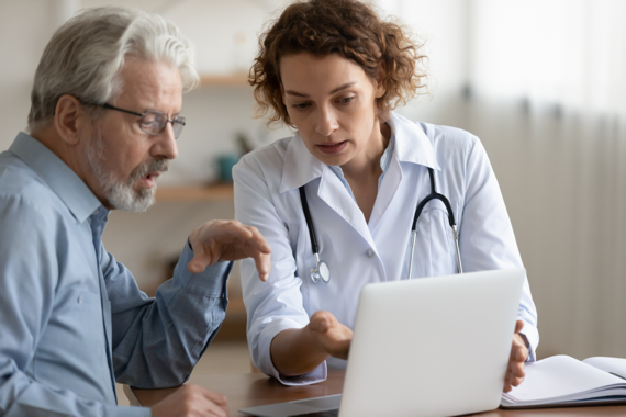 Hypothetical doctor talking to a hypothetical POMALYST® (pomalidomide) patient with relapsed/refractory multiple myeloma while showing them their laptop